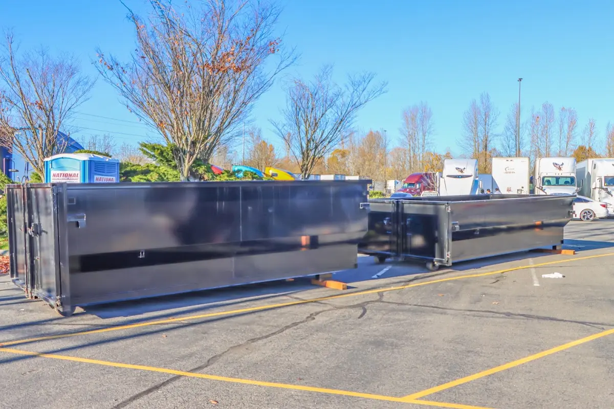 Professional dumpster rental service with roll-off container on residential driveway in Tahlequah